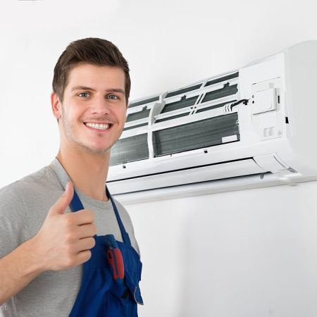 Young Happy Male Technician Gesturing Thumb Up Young Happy Male Technician Gesturing Thumb Up